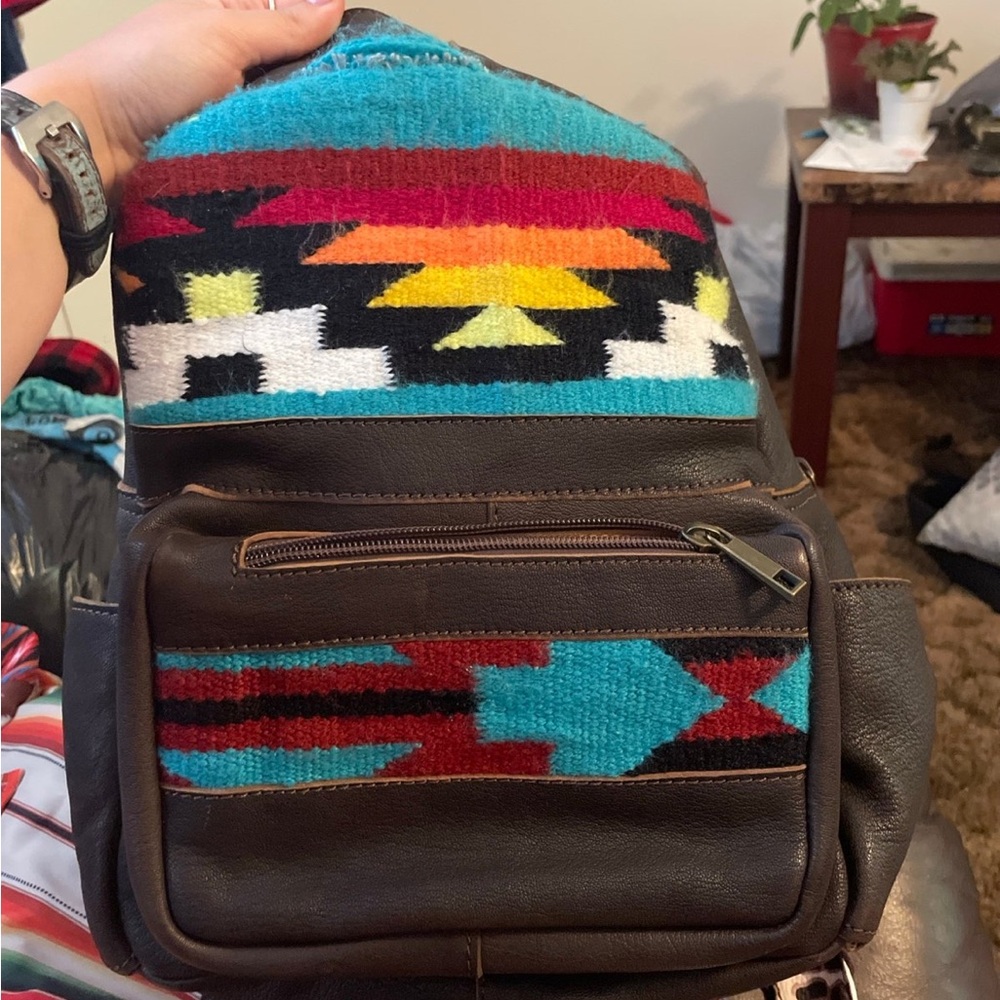 American Darling, backpack, has a little tear on the top as shown.